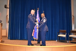 Chief Master Sgt. Aaron Doss (right) accepts the unit flag from Col. Philip Warlick, 655th Intelligence, Surveillance and Reconnaissance (ISR) Wing commander, during an assumption of command ceremony Aug. 3, 2024.