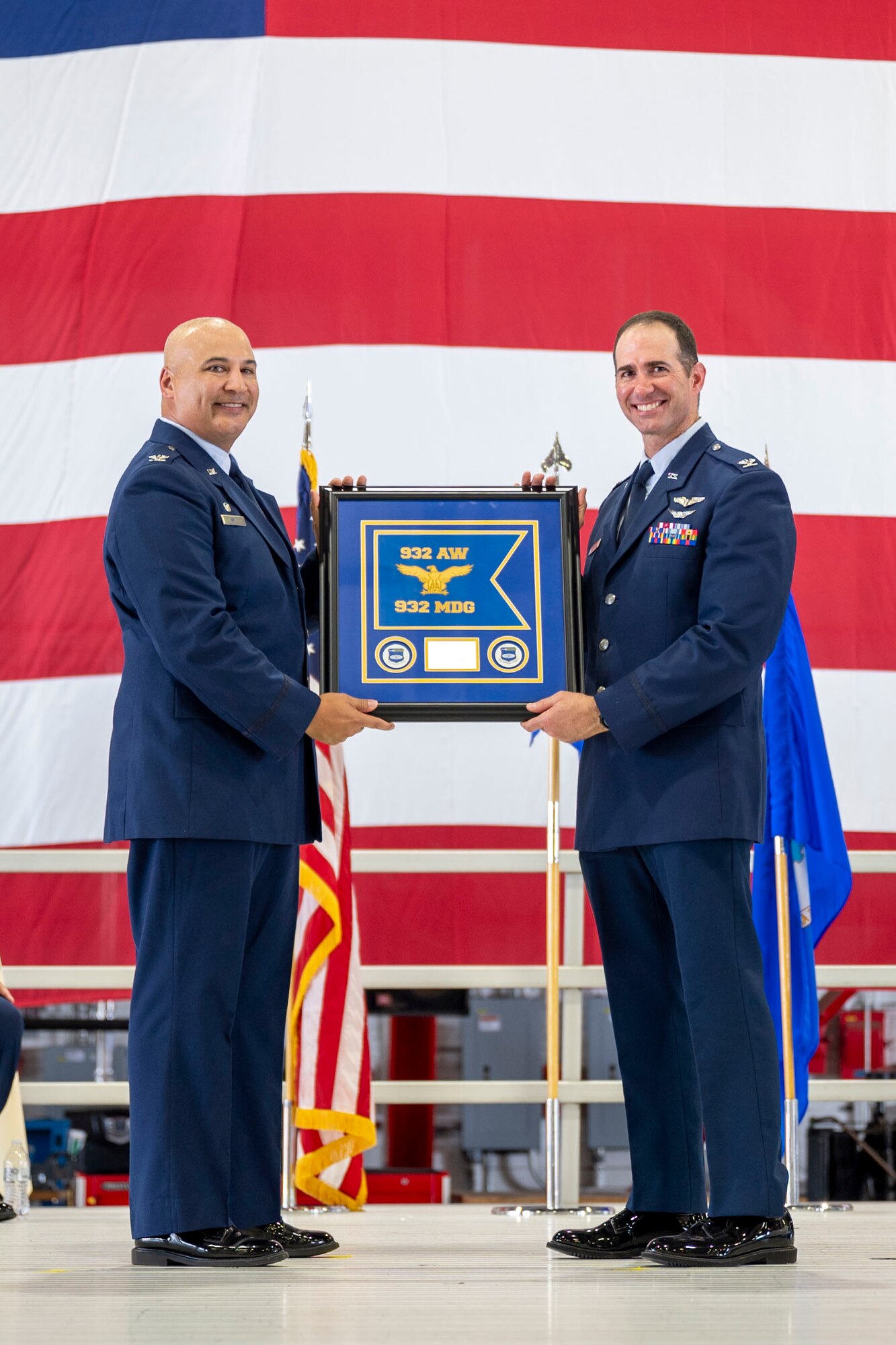 During the 932nd Airlift Wing August unit training assembly, Col. Christopher Spinelli, outgoing 932nd Medical group commander, relinquished command to Col. Robert Garner, incoming 932nd MDG commander. Col. Jeffery Smith, 932nd AW commander, presented Garner with the 932nd MDG guidon during the Change of Command ceremony held Aug. 3rd, 2024 at Hangar 1, Scott Air Force Base, Illinois. (U.S. Air Force Photo by SSgt Brooke Spenner)