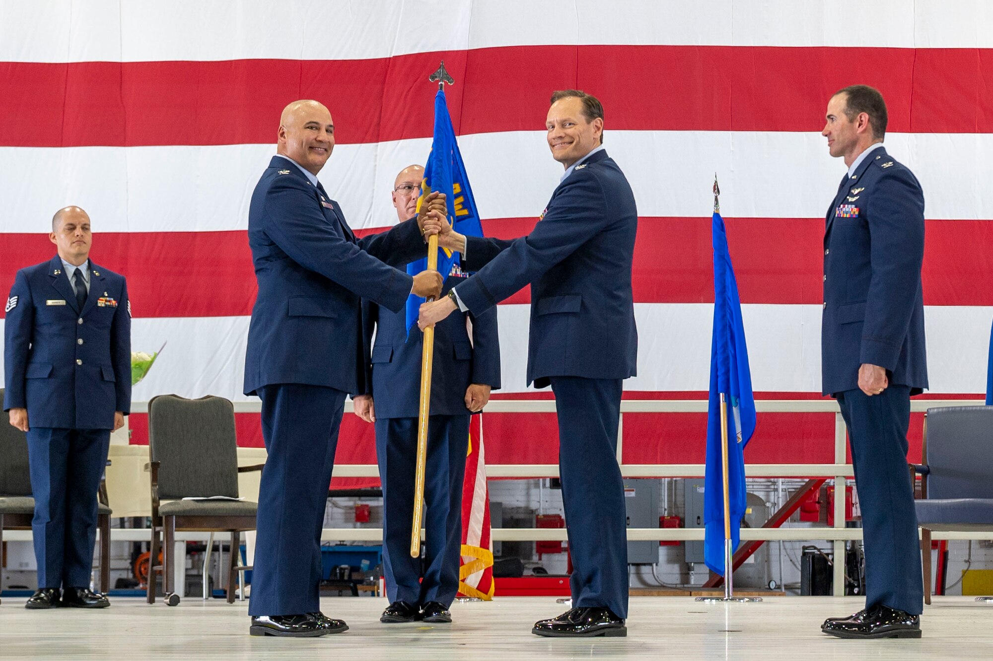 During the 932nd Airlift Wing August unit training assembly, Col. Christopher Spinelli, outgoing 932nd Medical group commander, relinquished command to Col. Robert Garner, incoming 932nd MDG commander. Col. Jeffery Smith, 932nd AW commander, presented Garner with the 932nd MDG guidon during the Change of Command ceremony held Aug. 3rd, 2024 at Hangar 1, Scott Air Force Base, Illinois. (U.S. Air Force Photo by SSgt Brooke Spenner)