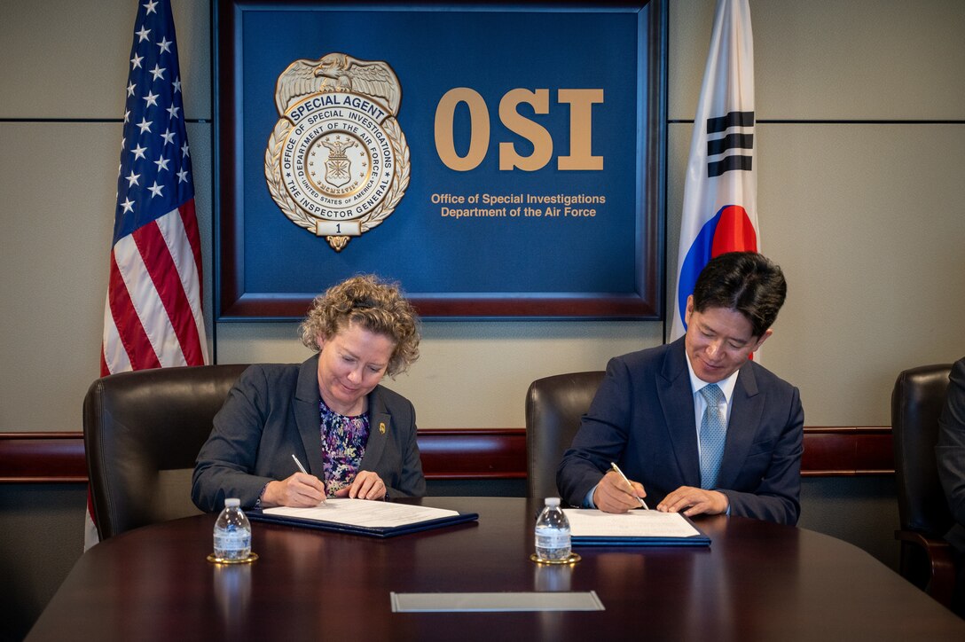 Brig. Gen. Amy Bumgarner, OSI's commander, and Senior Superintendent General Seung Hyup Lee sign a Memorandum of Understanding at OSI headquarters in Quantico, Virginia, July 24, 2024. The MOU establishes a deeper commitment to joint collaboration on cybersecurity and criminal intelligence.