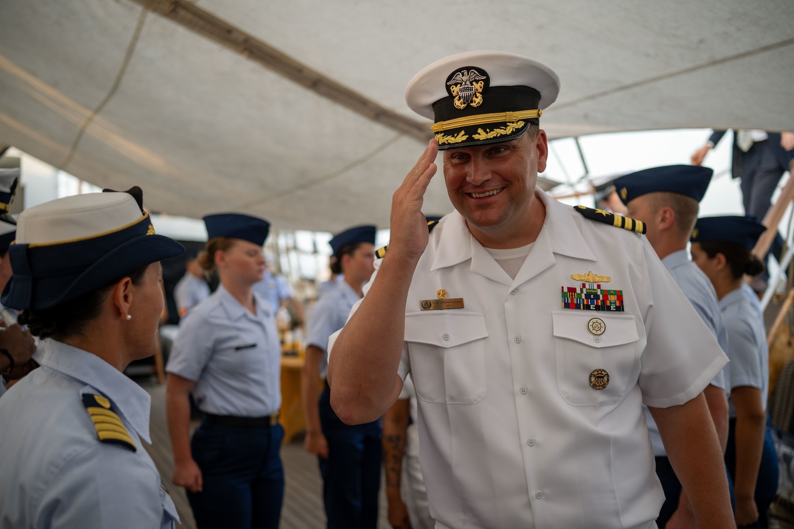 U.S. Navy Cmdr. Jeremiah Chase, right, commanding officer of USS Delbert D. Black (DDG 119) salutes U.S. Coast Guard Capt. Jessica Rozzi-Ochs, left, commanding officer of U.S. Coast Guard Cutter Eagle (WIX 327) during a reception to celebrate Rockland, Maine, recertifying as an official Coast Guard City, in Rockland, Aug. 2, 2024. Eagle’s command, crew and Coast Guard Academy cadets hosted members from the USS Delbert D. Black, the Coast Guard’s First District, Sector Northern New England, Station Rockland, Rockland officials, and community members while the ship was anchored in Rockland Harbor