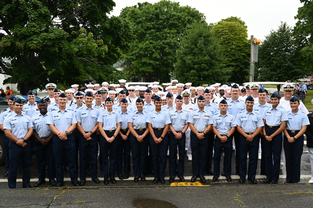 U.S. Coast Guard and U.S. Navy members take a group photo at the Main Lobster Festival Big Parade, in Rockland, Maine, August 3, 2024. Coast Guard Station Rockland, U.S. Coast Guard Cutter Eagle (WIX 327), Coast Guard Academy cadets and members from the USS Delbert D. Black participated in the parade.