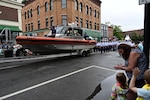 Coast Guard members from the U.S. Coast Guard Cutter Eagle (WIX 327), Coast Guard Station Rockland and Coast Guard Academy cadets march in a parade for the Maine Lobster Festival in Rockland, Maine, August 3, 2024. The Academy Cadets were embarked on Eagle for a week of at-sea training.