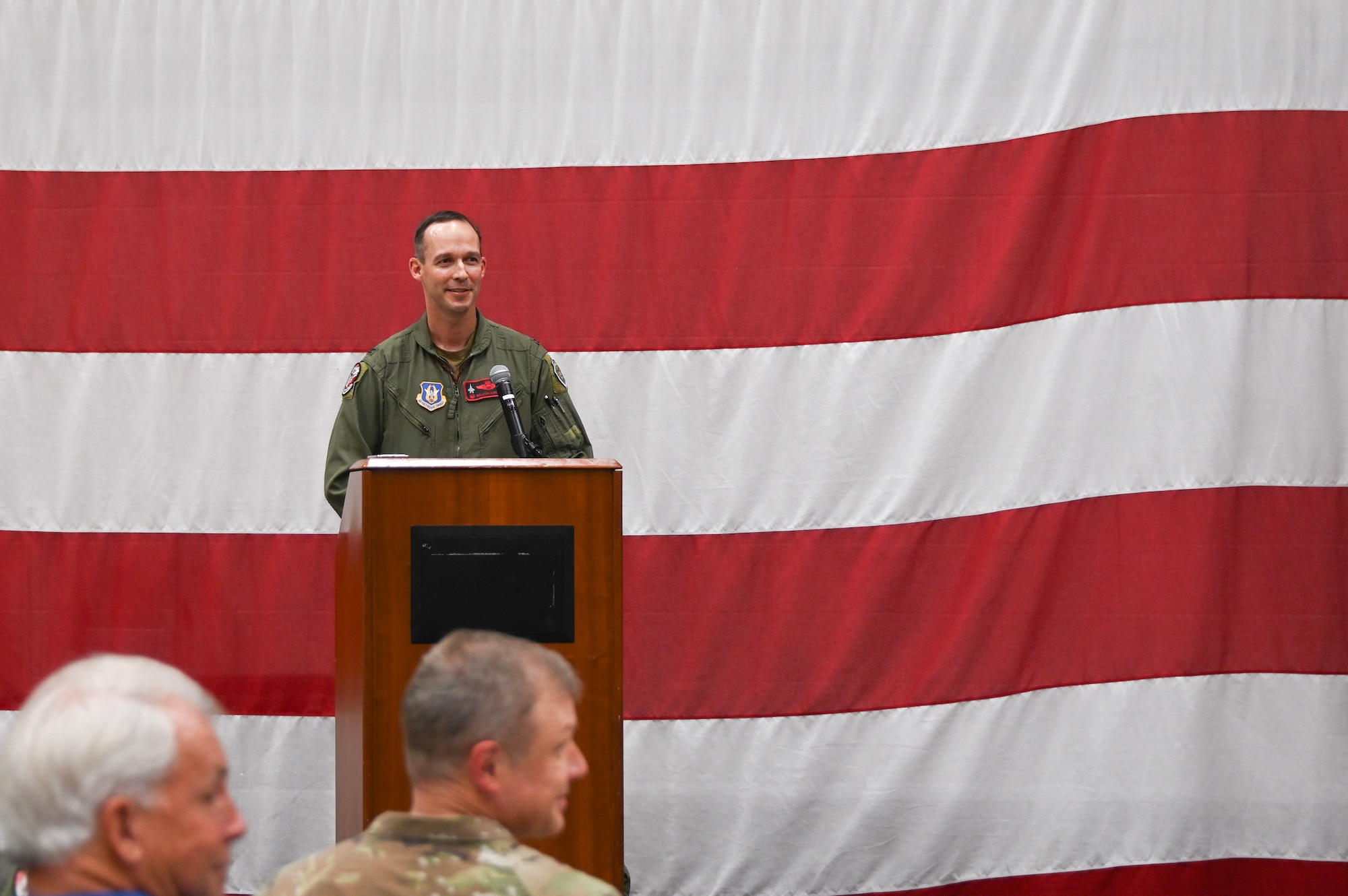U.S. Air Force Col. Benjamin Harrison, 301st Fighter Wing commander, gives a speech as the presiding officer of the 301st Operations Group assumption of command ceremony Aug. 3, 2024 at Naval Air Station Joint Reserve Base Fort Worth, Texas. During his speech, Harrison highlighted the impact and excellence that Lt. Col. David Snodgrass, new 301st OG commander, brings to the unit.