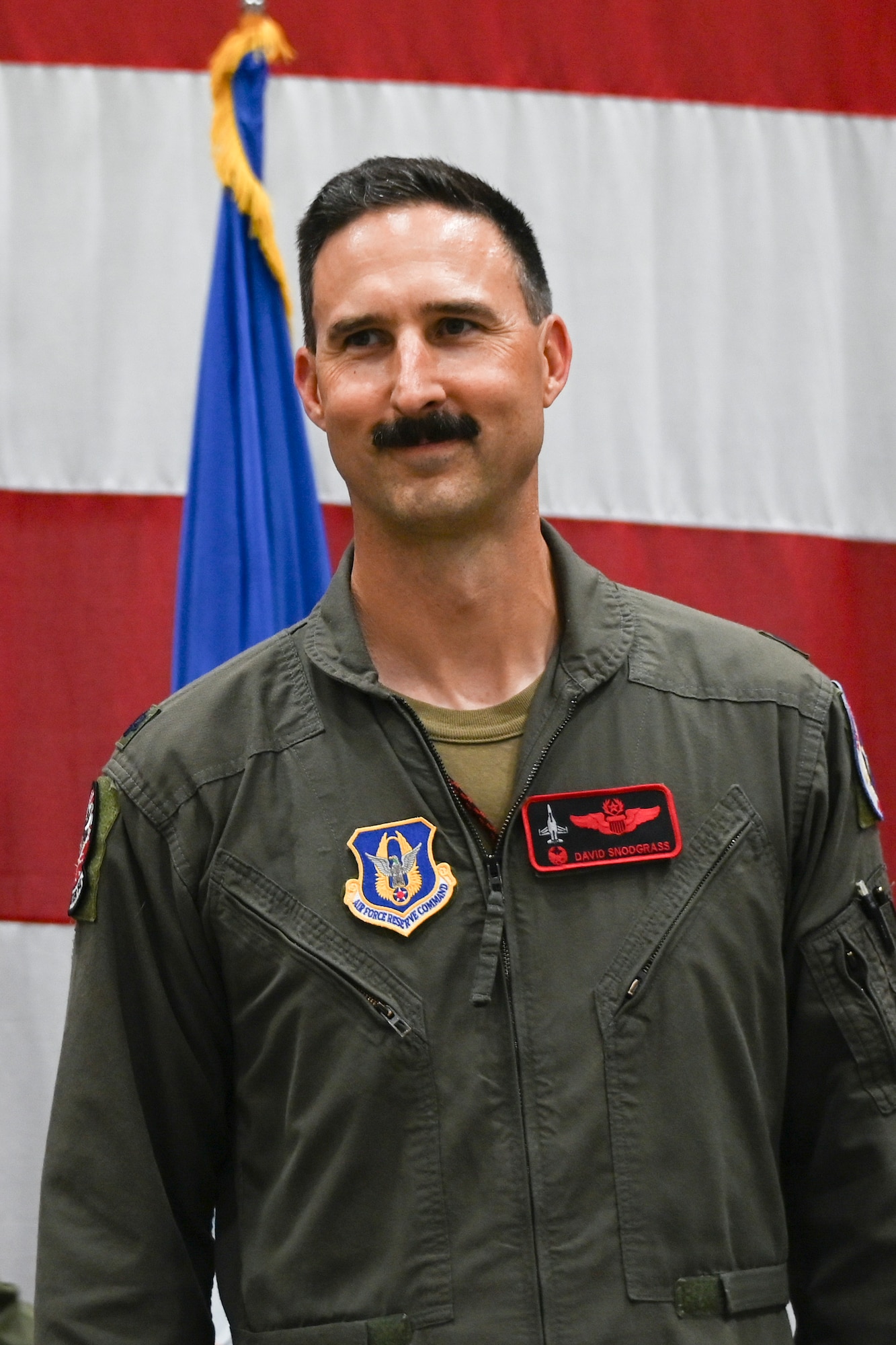 U.S. Air Force Lt. Col. David Snodgrass, 301st Operations Group commander, smiles at the audience after assuming command of the 301st OG Aug. 3, 2024 at Naval Air Station Joint Reserve Base Fort Worth, Texas. Snodgrass emphasized his readiness to utilize the enhanced capabilities that the F-35 brings.
