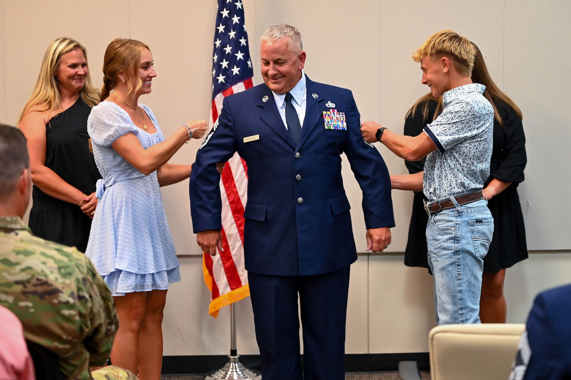 Chief Master Sgt. Kevin D. Brannan’s children pin on his stripes during the promotion ceremony on Aug. 3, 2024 at Naval Air Station Joint Reserve Base Fort Worth, Texas. Brannan serves as an air reserve technician and aerial port manager for the 73rd Aerial Port Squadron.