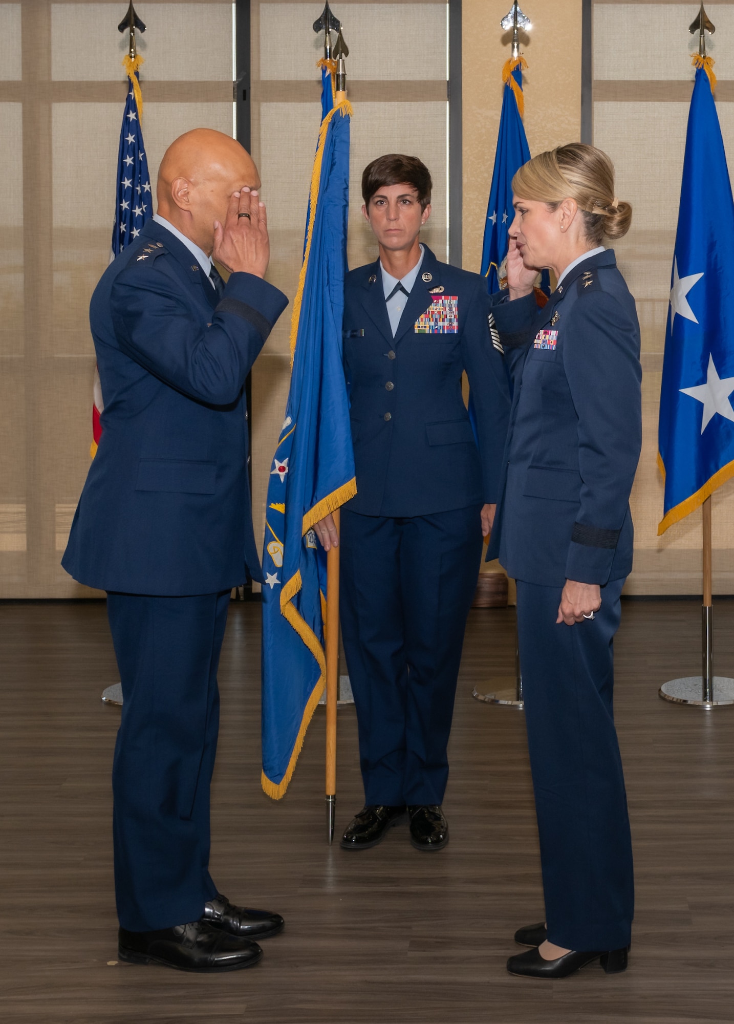 U.S. Air Force Lt. Gen. Brian Robinson, Air Education and Training Command commander, receives a salute from Maj. Gen. Michele Edmondson, Second Air Force outgoing commander, as she prepares to relinquish command during the Second Air Force change of command ceremony inside the Bay Breeze Event Center at Keesler Air Force Base, Mississippi, Aug 2, 2024.