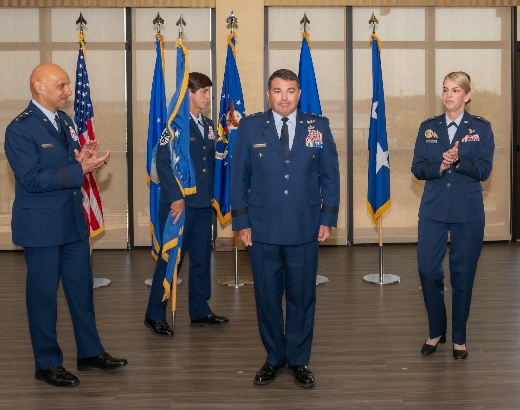U.S. Air Force Lt. Gen. Brian Robinson, Air Education and Training Command commander, and Maj. Gen. Michele Edmondson, Second Air Force outgoing commander, congratulates Maj. Gen. Matthew Davidson, Second Air Force commander, during the Second Air Force change of command ceremony inside the Bay Breeze Event Center at Keesler Air Force Base, Mississippi, Aug 2, 2024.