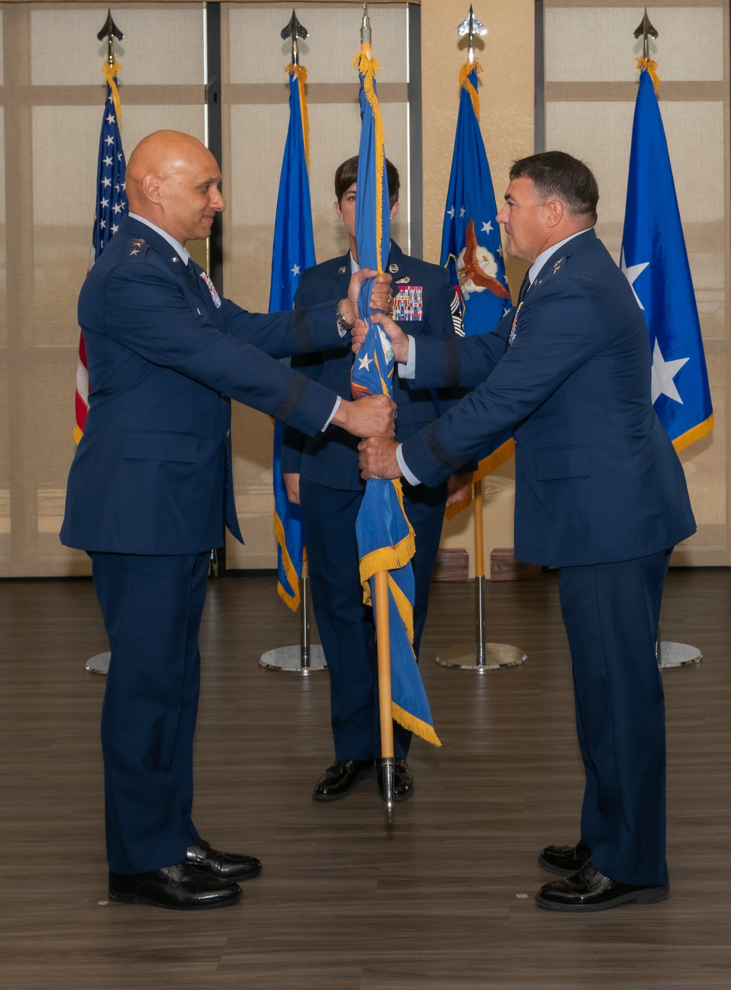 U.S. Air Force Lt. Gen. Brian Robinson, Air Education and Training Command commander, presents the guidon to Maj. Gen. Matthew Wolfe Davidson, Second Air Force commander, as he assumes command during the Second Air Force change of command ceremony inside the Bay Breeze Event Center at Keesler Air Force Base, Mississippi, Aug 2, 2024.