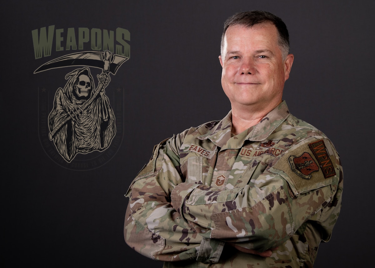 Studio portrait of MSgt John Eaves on right with reaper weapons logo digitally added on left.
