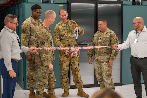 U.S. Air Force Airman and civilian partners cut a ribbon signifying the completion of renovations to the Scott AFB Data Center.