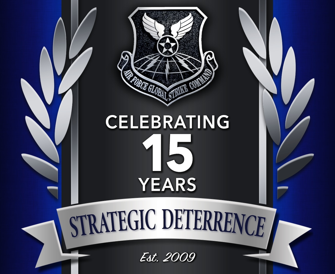 A graphic for the 15th anniversary of the founding Air Force Global Strike Command. The graphic features a dark blue textured background with a dark gray stripe in the middle of the screen that runs from top to bottom. There are silver wings on either side of the dark gray stripe. The very center of the design shows a silver and metallic looking version of the AFGSC shield. Below the shield are the words, "Celebrating 15 years" in white font. Underneath those words, on a horizontal silver banner is the text, "Strategic Deterrence" in a dark blue font. Underneath the banner is the text, "Est. 2009" in a white script font.