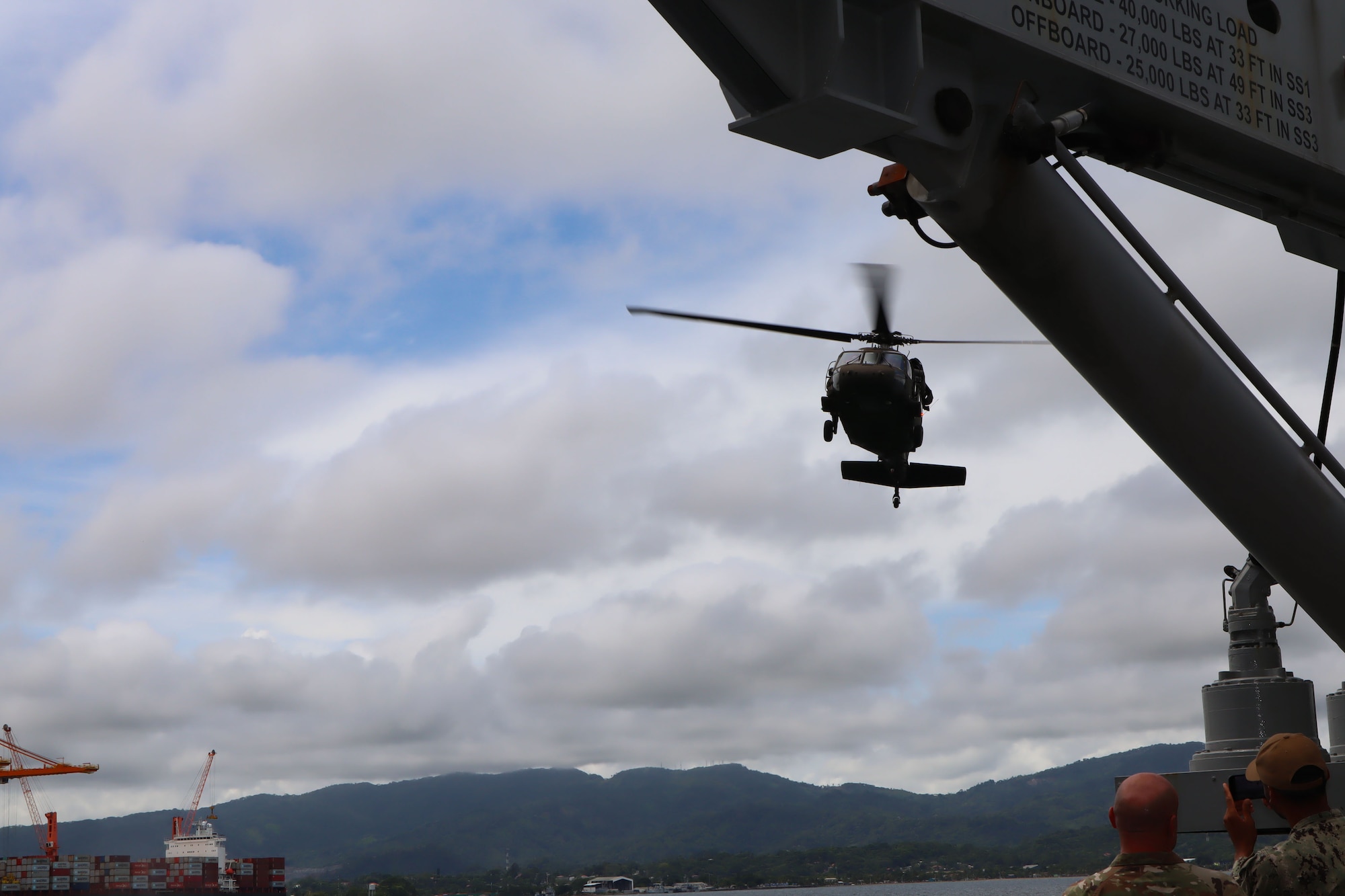 A photo of a helicopter near a ship.