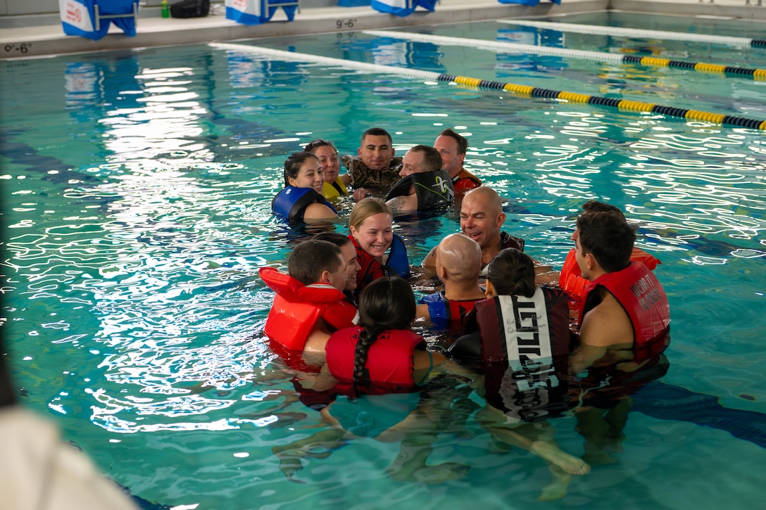 Crewmembers from the U.S. Coast Guard Cutter Kimball (WMSL 756) and Marine Safety Unit Dutch Harbor participate in a train-the-trainer event for ‘Kids Don’t Float,’ a statewide initiative to teach the importance of lifejacket safety and the effects of cold-water immersion, during Kimball’s port call in Dutch Harbor, Alaska, May 18, 2024. Kimball’s crew conducted multiple community outreach events during their port calls throughout Alaska during their 122-day patrol. U.S. Coast Guard photo by Petty Officer 3rd Class Crystal Han.