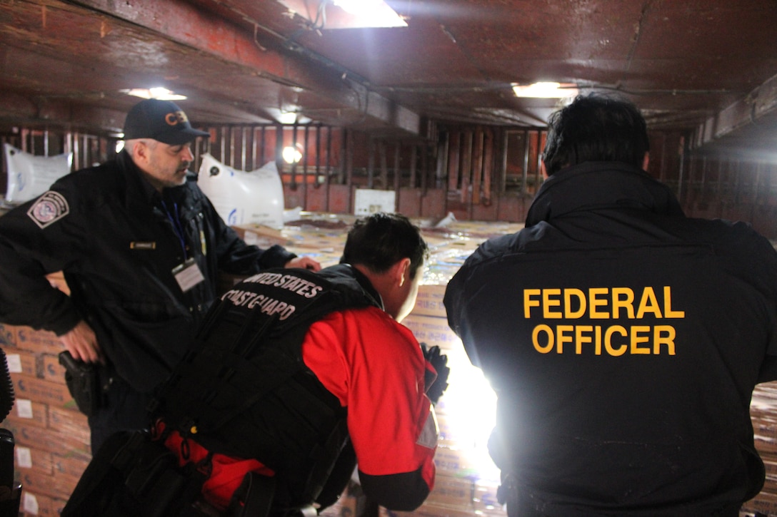 A U.S. Coast Guard Cutter Kimball (WMSL 756) law enforcement boarding team alongside officers from Customs and Border Protection and the NOAA Office of Law Enforcement inspect fish bait during a joint boarding of M/V Suah near Dutch Harbor, Alaska, June 22, 2024. Kimball’s crew ensured fishing vessels in the Bering Sea were within compliance of all federal fishery conservation laws and safety requirements through the completion of twenty living marine resources boardings during their 122-day patrol U.S. Coast Guard photo by Ensign James Bongard.