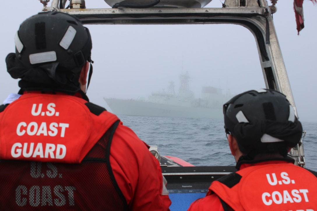 U.S. Coast Guard Cutter Kimball (WMSL 756) crew members aboard a 26-foot over-the-horizon IV cutter boat observe as the Kimball conducts a passing exercise with the Royal Canadian Navy ship HMCS Regina while Kimball patrols the Bering Sea, July 18, 2024. During Kimball’s 122-day patrol, the crew interacted with strategic partners in Victoria, Canada, strengthening relationships by focusing on shared interests in the Bering Sea and the expanding Artic region. U.S. Coast Guard photo by Ensign James Bongard.