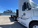 Truck with a ship in the background.