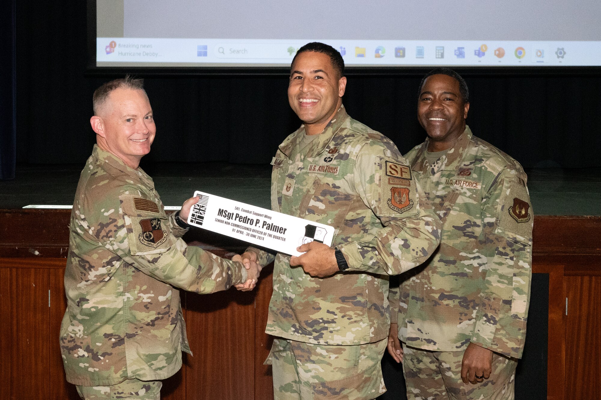 U.S. Air Force Col. D. Landon Phillips, 501st Combat Support Wing commander, left, and Chief Master Sgt. Terrance Boyd, 501st Combat Support Wing command chief, right, present Master Sgt. Pedro P. Palmer, 422nd Security Forces operations superintendent with a senior non-commissioned officer of the quarter award.