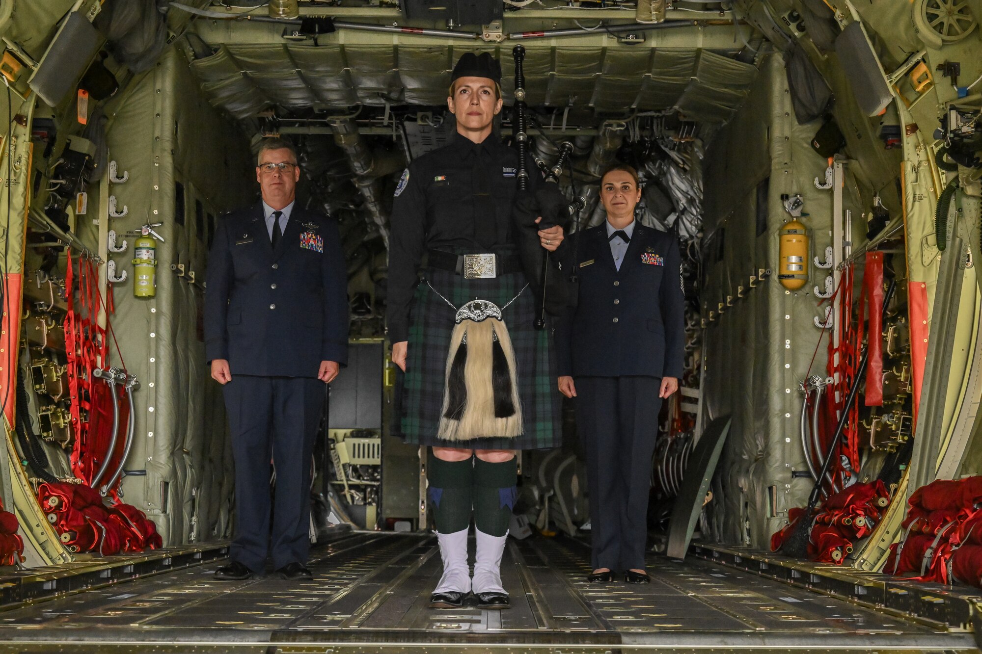 Col. Michael Maloney, 910th Airlift Wing commander, and Chief Master Sgt. Jennifer McKendree, 910th AW command chief, stand at attention at the start of McKendree's retirement ceremony at Youngstown Air Reserve Station, Ohio, Aug. 3, 2024.