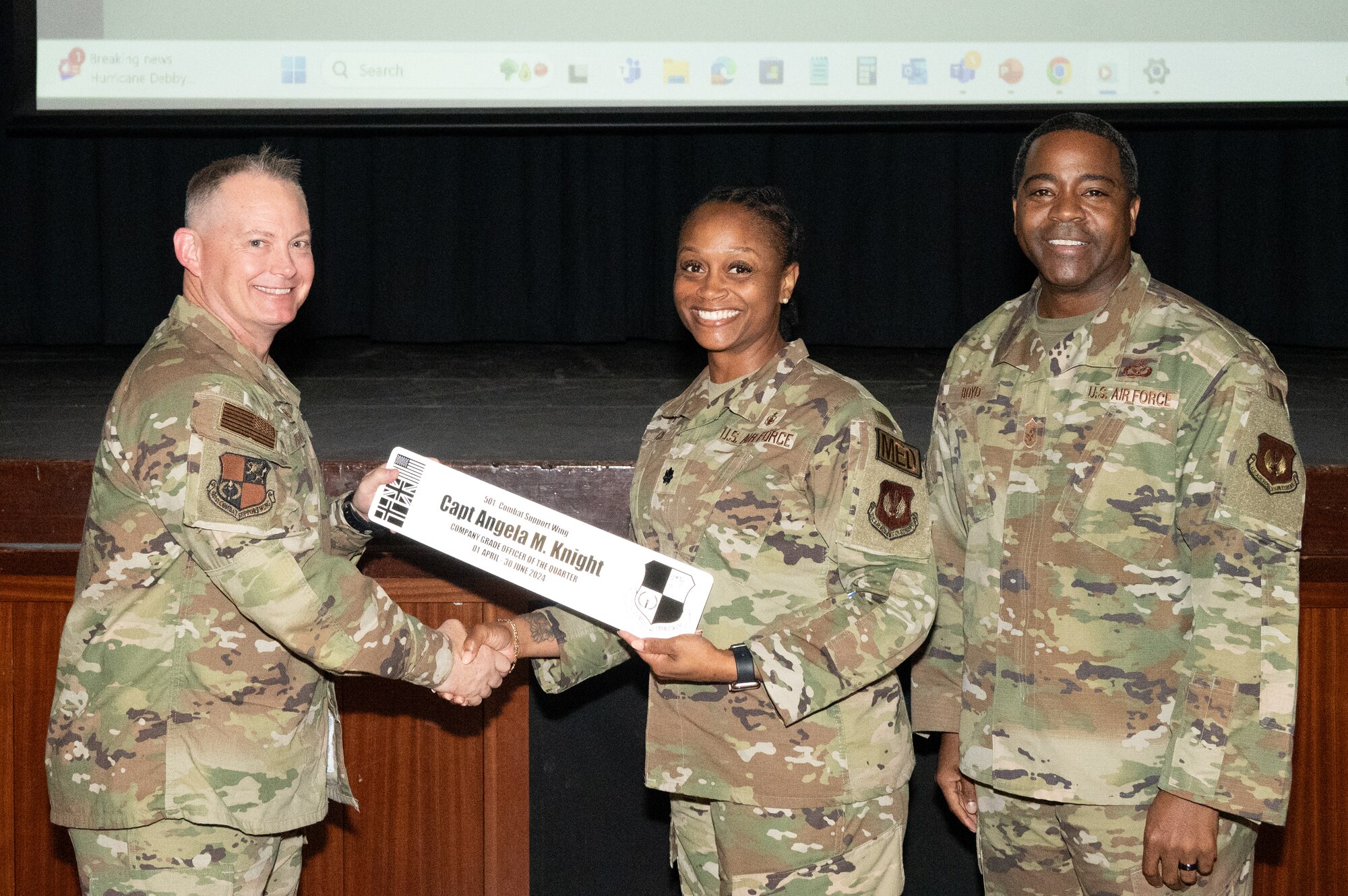 U.S. Air Force Col. D. Landon Phillips, 501st Combat Support Wing commander, left, and Chief Master Sgt. Terrance Boyd, 501st Combat Support Wing command chief, right, presents Lt. Col. Carla Cox, 422nd Medical Squadron (MDS) Commander with a company grade officer of the quarter award on behalf of Capt. Angela M. Knight, 422nd MDS Pathfinder.