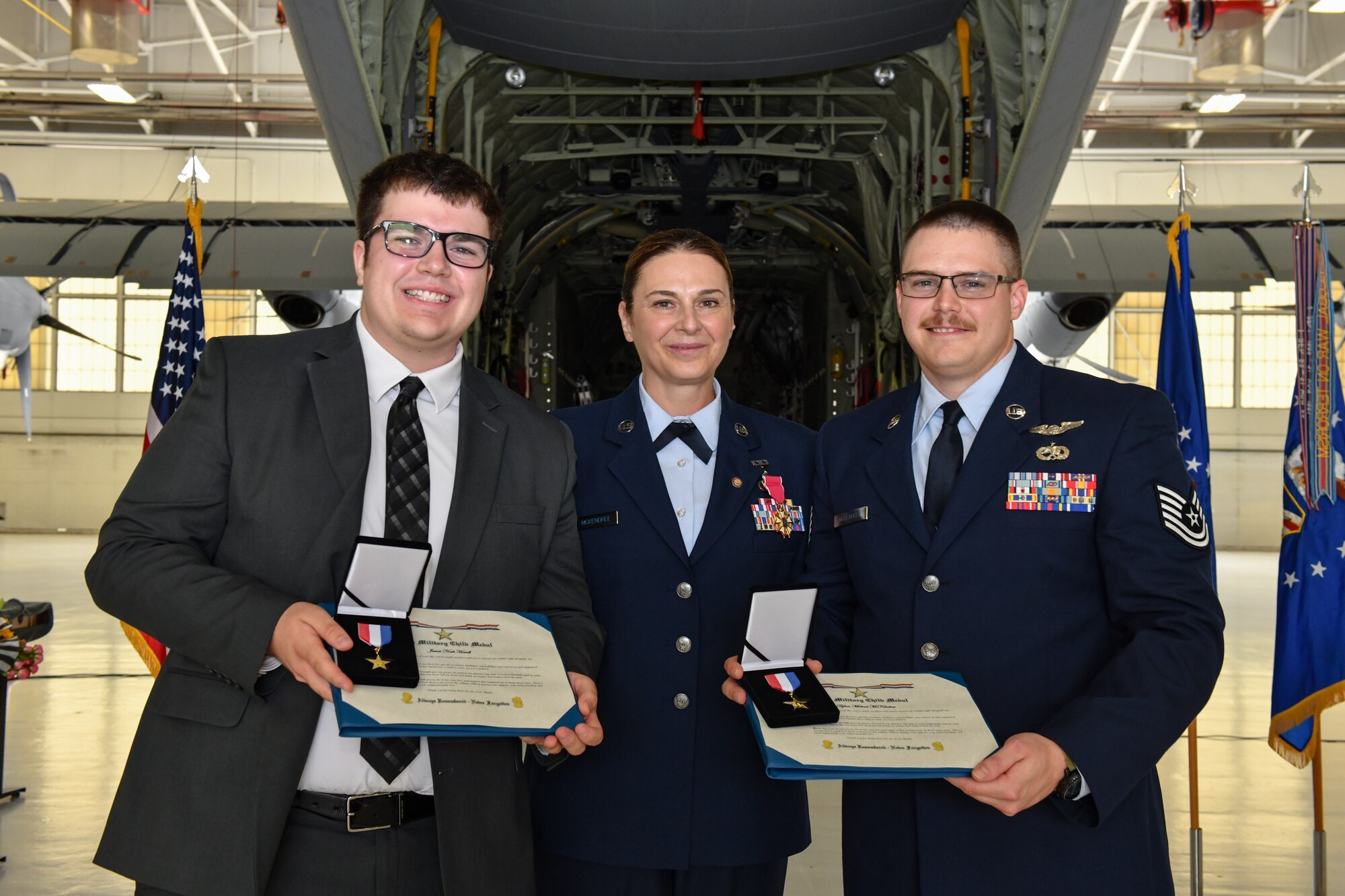 Chief Master Sgt. Jennifer McKendree, 910th Airlift Wing command chief, poses for a photo with her sons during her retirement ceremony at Youngstown Air Reserve Station, Ohio, Aug. 3, 2024.