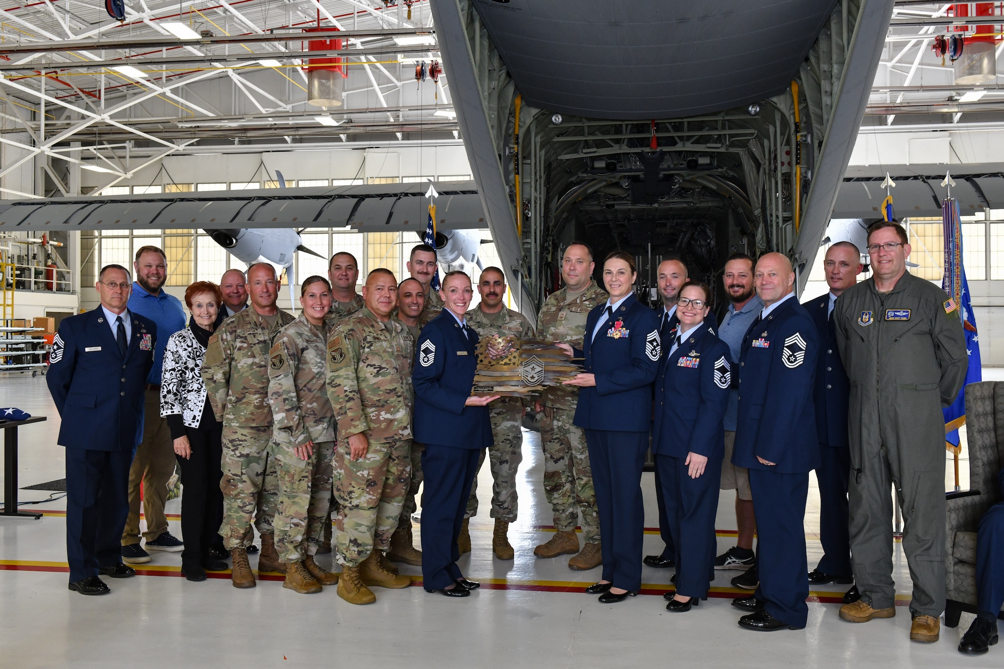 Chief Master Sgt. Jennifer McKendree, 910th Airlift Wing command chief, poses for a photo with fellow chiefs during her retirement ceremony at Youngstown Air Reserve Station, Ohio, Aug. 3, 2024.