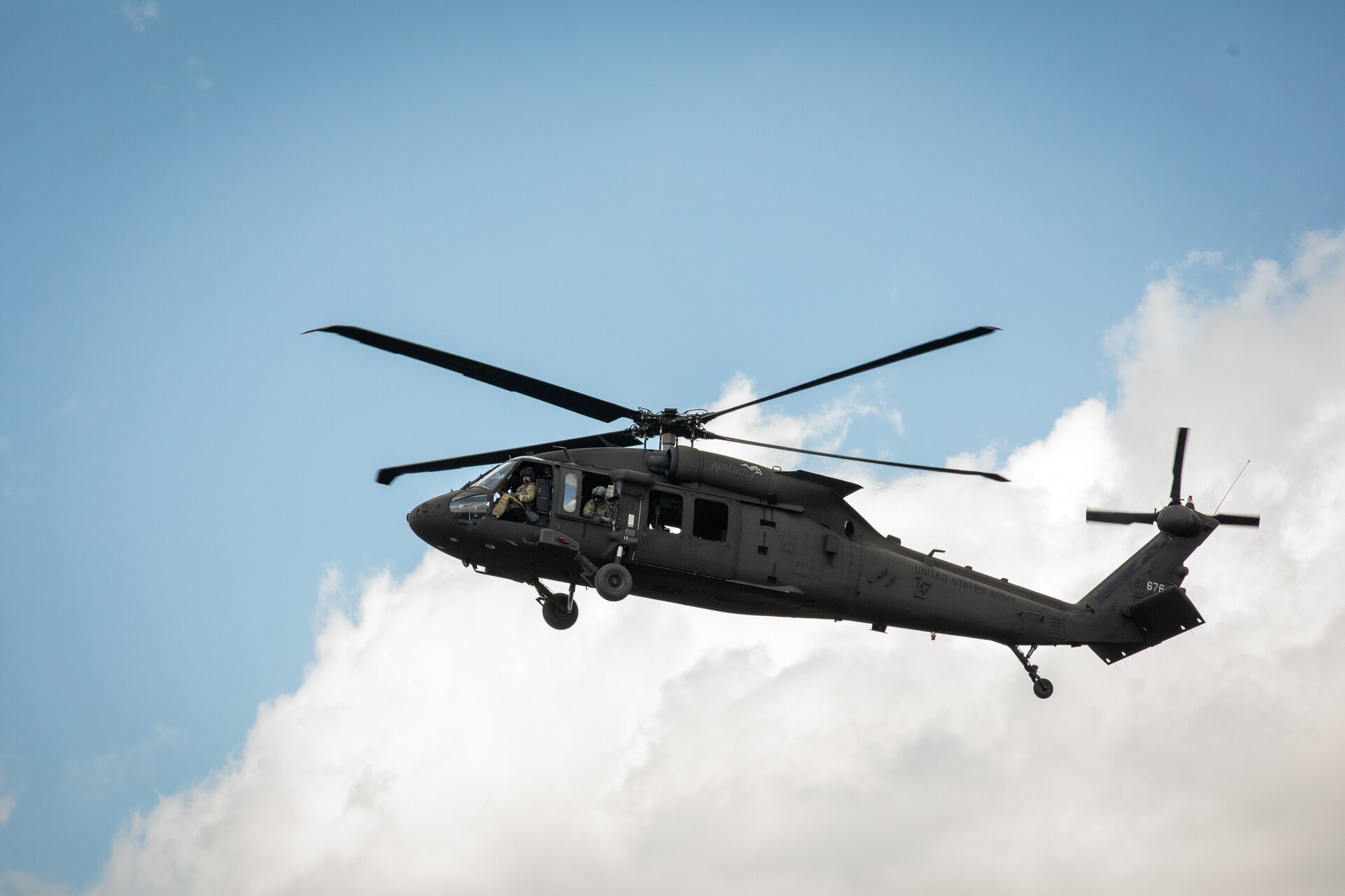 Soldiers with Bravo Co. 2/147th Assault Helicopter Battalion, 63rd Theater Aviation Brigade fly over Camp Grayling Army Airfield in Grayling, Michigan on July 16, 2024. Soldiers with Bravo Company conducted aerial gunnery at Camp Grayling for their annual training. (U.S. Army National Guard photo by Sgt. 1st Class Andrew Dickson)