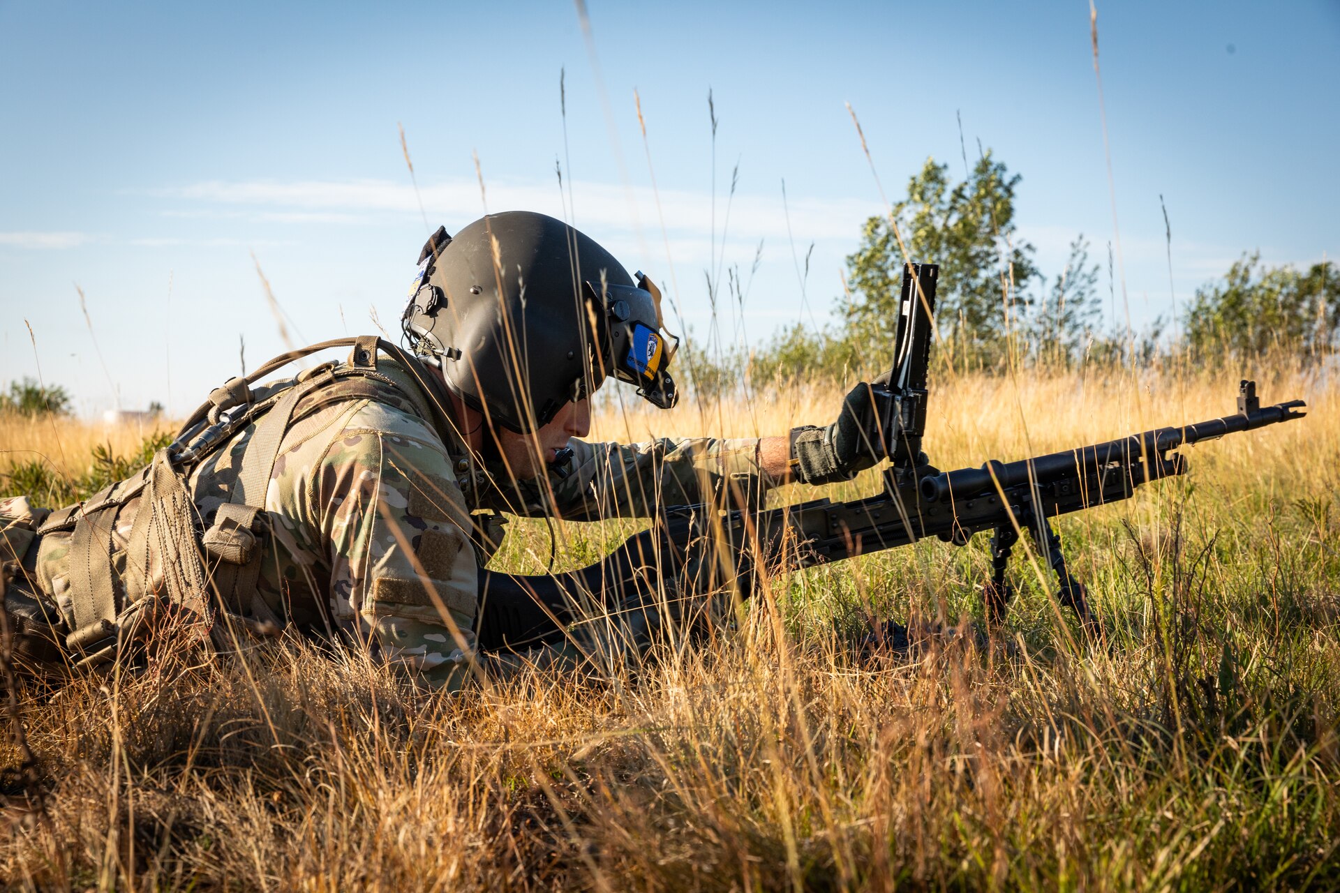 U.S. Army Sgt. Cameron Retallick clears the M240 machine gun after dismounted gunnery by a UH-60 Blackhawk at Camp Grayling Army Airfield in Grayling, Michigan on July 16, 2024. Retallick is a crew chief in Bravo Company 2/147th Assault Helicopter Battalion, 63rd Theater Aviation Brigade,  who was conducting aerial gunnery during their annual training. (U.S. Army National Guard photo by Sgt. 1st Class Andrew Dickson)