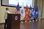Woman talking while standing at podium