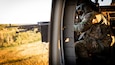 U.S. Army Spc. Austin Banks fires the M240 machine gun during mounted gunnery in a UH-60 Blackhawk at Camp Grayling Army Airfield in Grayling, Michigan on July 16, 2024. Banks is a crew chief in Bravo Company 2/147th Assault Helicopter Battalion, 63rd Theater Aviation Brigade,  who was conducting aerial gunnery during their annual training. (U.S. Army National Guard photo by Sgt. 1st Class Andrew Dickson)