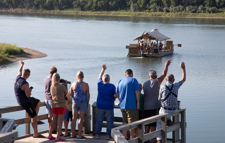Area campers wave at the boys of Bald Eagle Boys camp, based in Mills Hall, Pa., as they begin their 1,000-mile journey down the Missouri River at Yankton, Nebraska, on Aug. 3, 2024. The camp specializes in wilderness therapy for boys. (U.S. Army photo by Josh Plueger)
