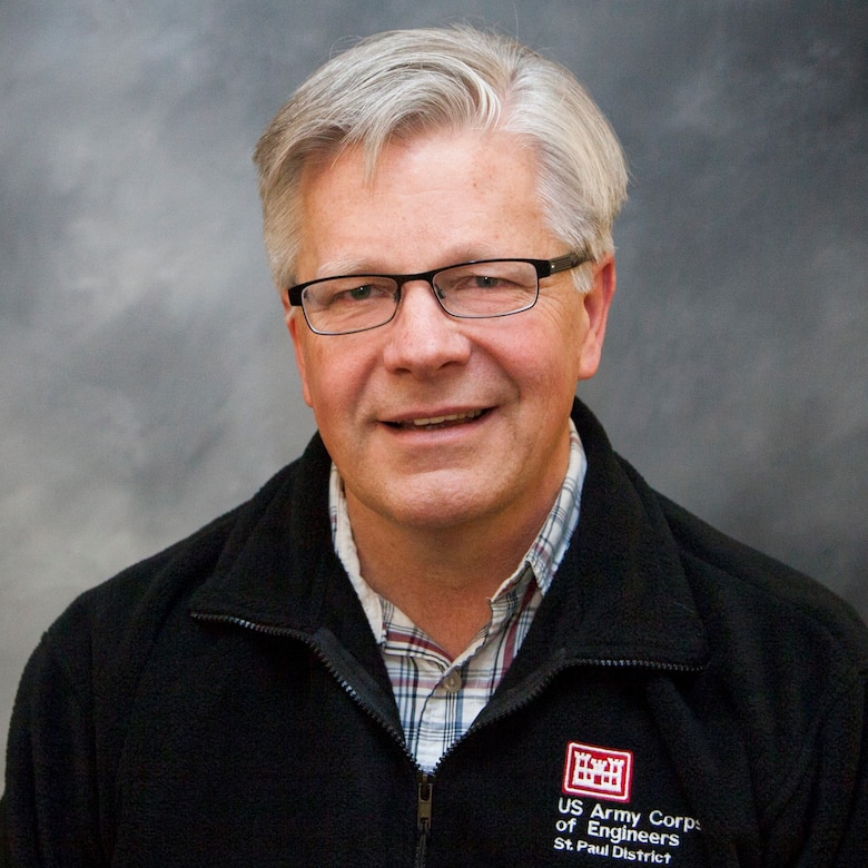 Man with black jacket smiling