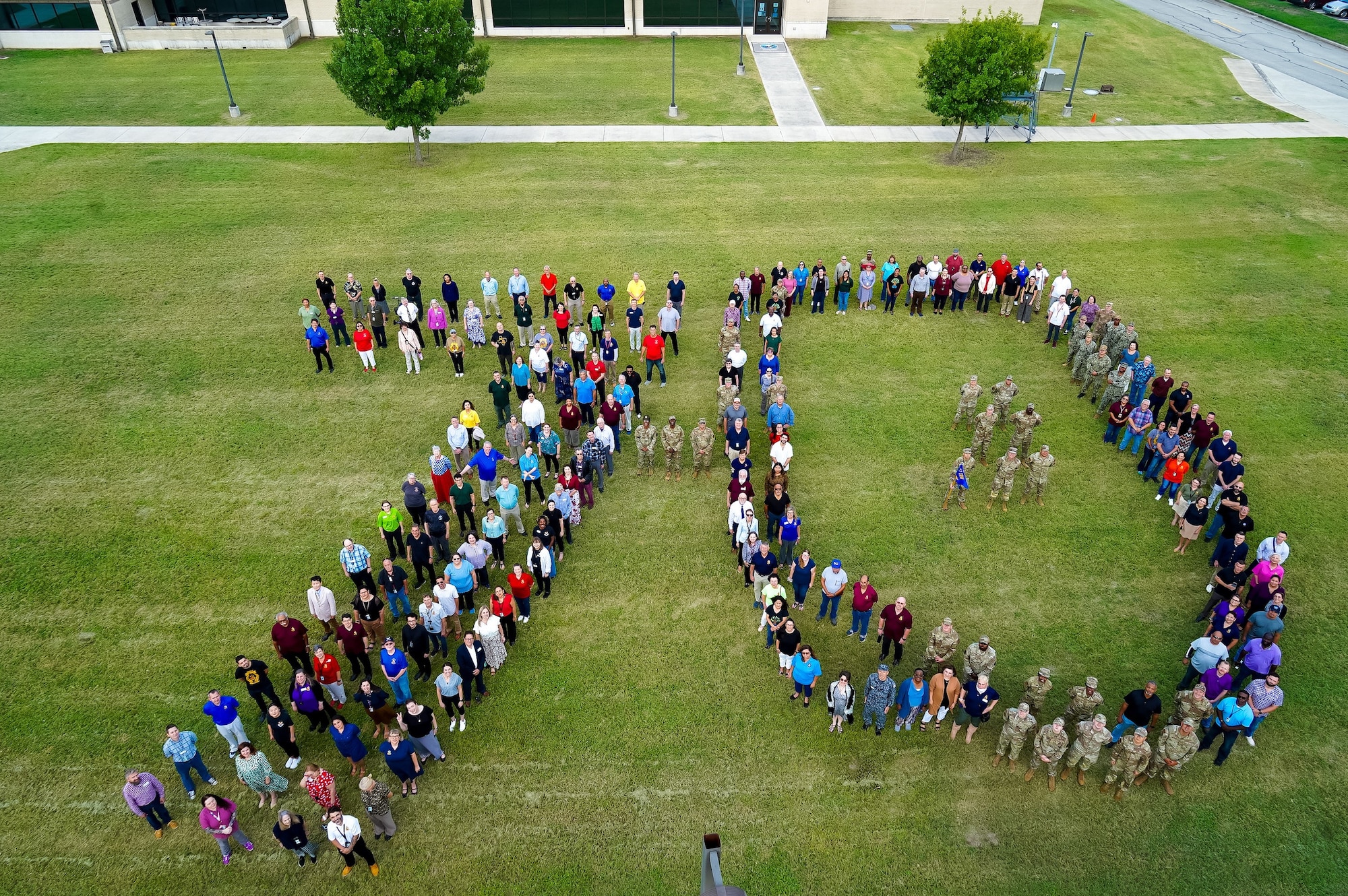 Members of the 637th Training Group and the 37th Training Wing form a “70” in celebration of the Defense Language Institute English Language Center’s 70th Anniversary, at Joint Base San Antonio-Lackland, Texas, July 31, 2024. DLIELC helps build security cooperation capability through English language training and cultural immersion to U.S. and international military and civilians.