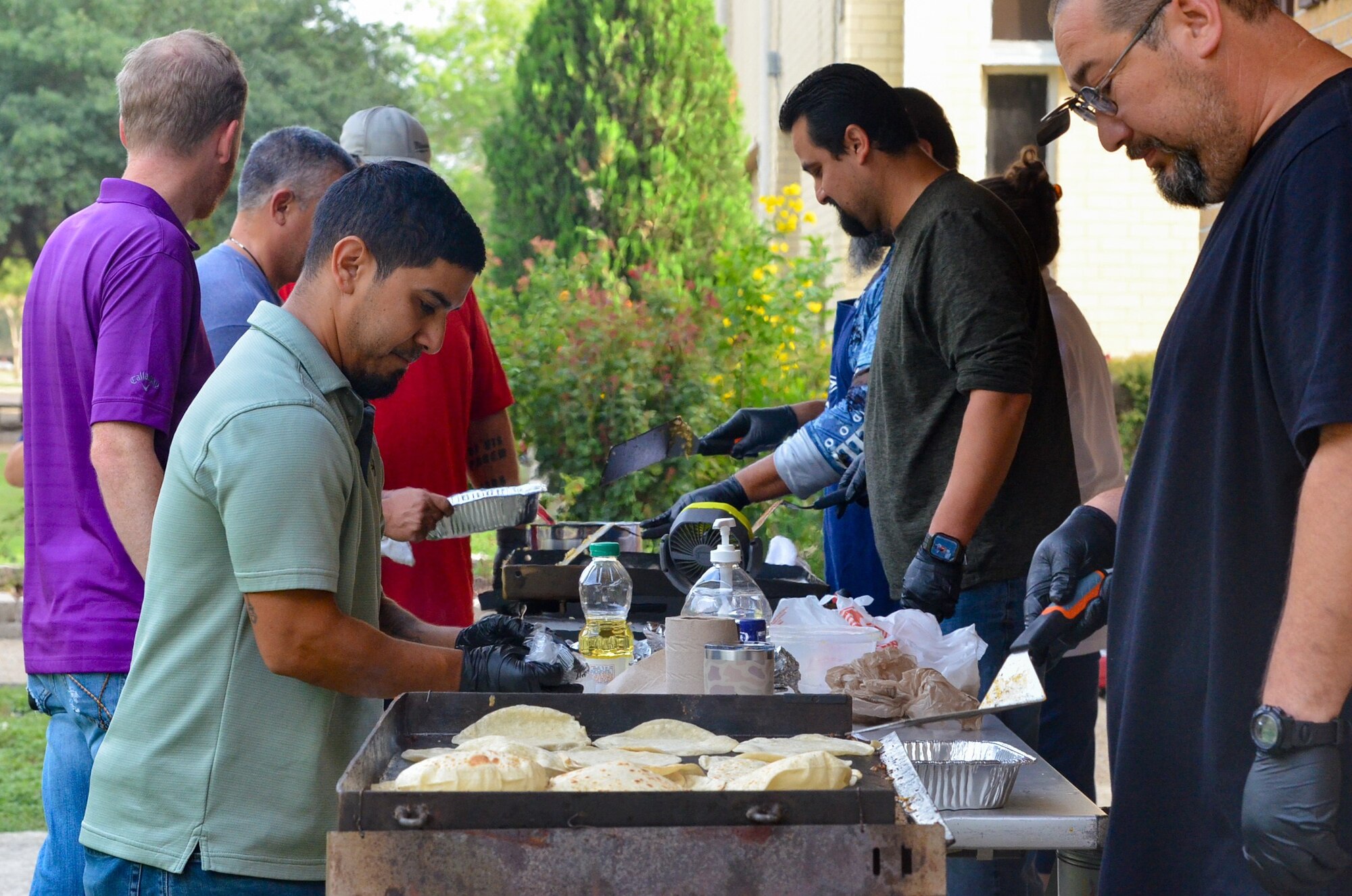 The 637th Training Group - Defense Language Institute English Language Center - warehouse team cooks and serves breakfast during the 70th Anniversary festivities at Joint Base San Antonio-Lackland, Texas, July 31, 2024.