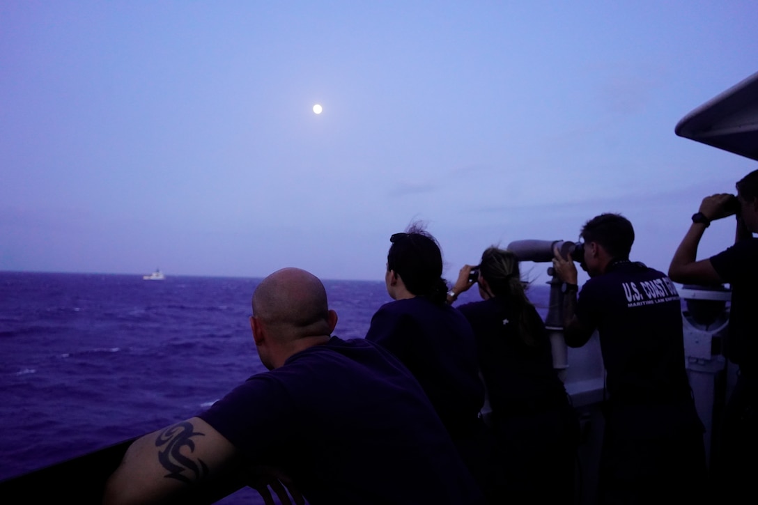 Cadet 1/c Matt Lubin, Ensign Lillia Farlow, Cmdr. Karen Kutkiewicz, Petty Officer 2nd Class Reese Davidson, and U.S. Merchant Marine Academy Midshipman Cole Hite observe the Coast Guard Cutter Venturous’ small boat crew conducting a transfer of detainees with the Coast Guard Cutter Forward in the Windward Pass on July 18, 2024. Venturous’ crew conducted a 60-day maritime safety and security patrol in the Windward Passage and Florida straits. (U.S. Coast Guard photo by Ensign Dev Craig)