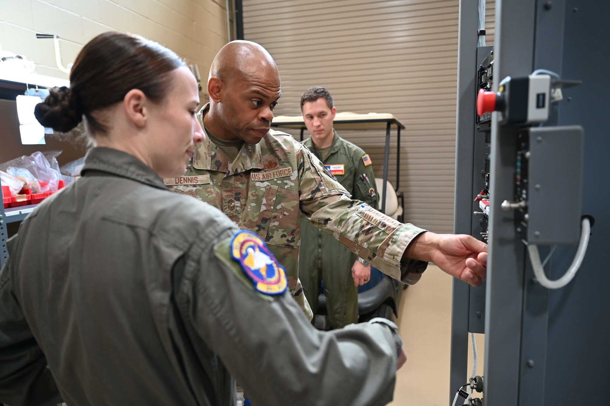 Staff Sgt. Logann Rapier, 68th Airlift Squadron loadmaster, walks Chief Master Sgt. Travon Dennis, 4th Air Force command chief, through a demonstration of a C-5M Super Galaxy ramp and door training unit at the 733rd Training Squadron during a 4th Air Force visit to Joint Base San Antonio-Lackland, Texas, Aug. 3, 2024.