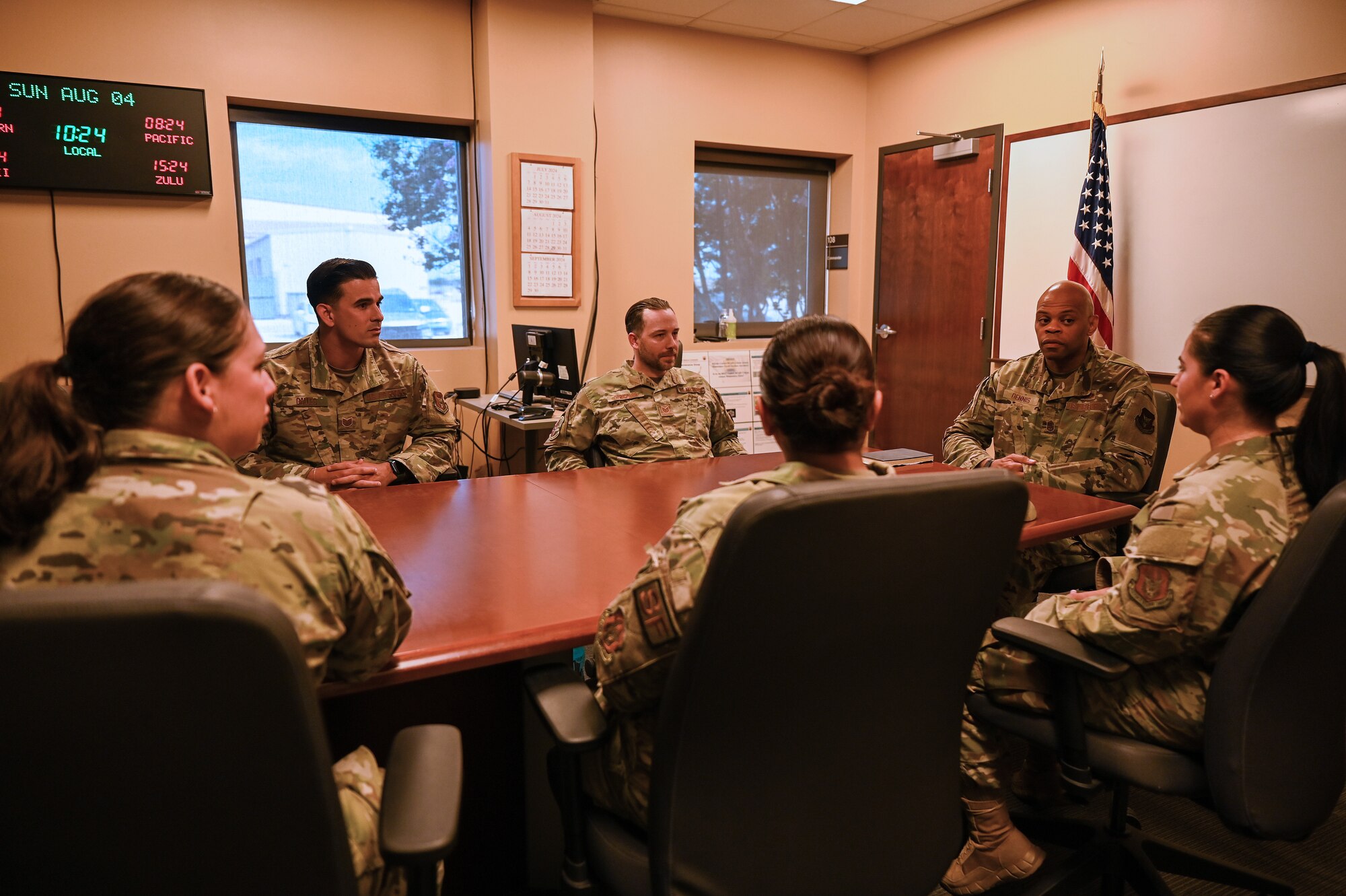 Chief Master Sgt. Travon Dennis, 4th Air Force command chief, visits with the leadership committee of the 433rd Airlift Wing’s Rising Six council at Joint Base San Antonio-Lackland, Texas, Aug. 4, 2024.