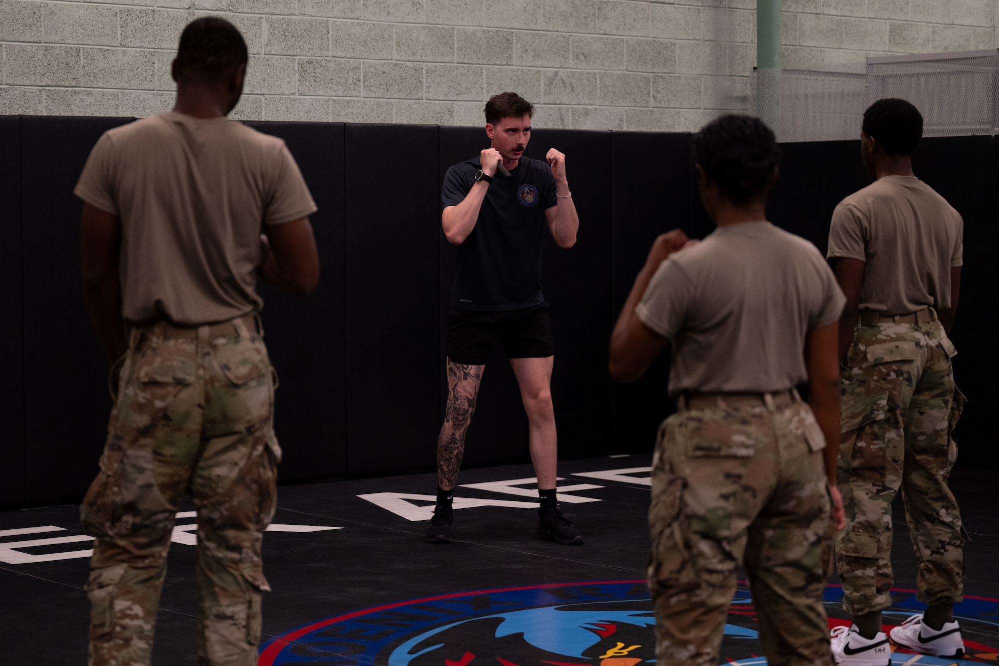 U.S. Air Force Senior Airman Robert Vanlaer, 436th Security Forces Squadron Phoenix Ravens team member, leads a class through a non-lethal baton training at the Ravens training building at Dover Air Force Base, Aug. 6, 2024. The baton is one of the basic skills that Airmen in Security Forces learn during their training. (U.S. Air Force photo by Airman Liberty Matthews)