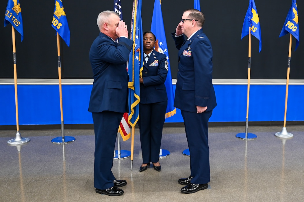 Maj. Gen. D. Scott Durham, 4th Air Force commander, and Col. Douglas C. Jeffrey, IV, 433rd Airlift Wing commander, salute each other during the 433rd AW assumption of command ceremony at Joint Base San Antonio-Lackland, Texas, Aug. 4, 2024.