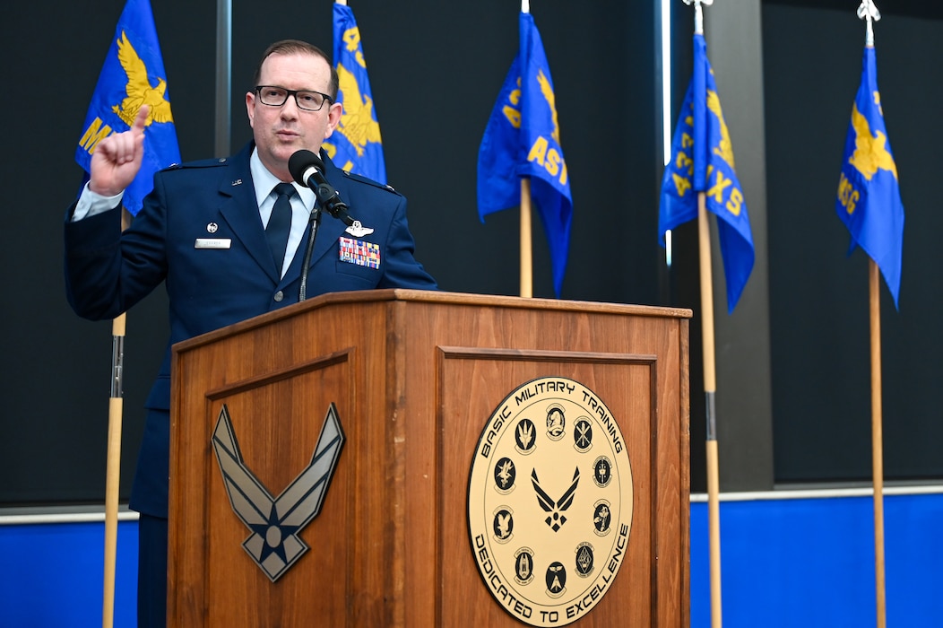 Col. Douglas C. Jeffrey, IV, 433rd Airlift Wing commander, addresses an audience of 433rd AW Citizen Airmen and community members at the 433rd AW assumption of command ceremony after receiving the guidon from Maj. Gen. D. Scott Durham, 4th Air Force commander at Joint Base San Antonio-Lackland, Texas, Aug. 4, 2024.