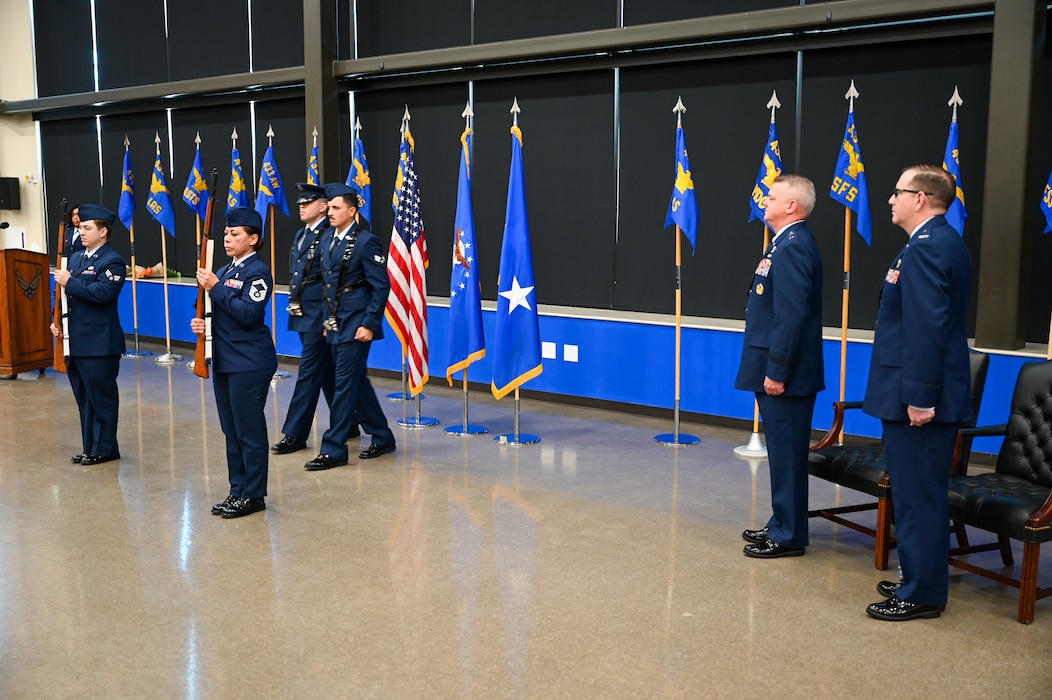 Maj. Gen. D. Scott Durham, 4th Air Force commander, Col. Jeffrey Douglas, IV, 433rd Airlift Wing commander, and members of the 433rd AW stand at attention for an Honor Guard presentation during the 433rd AW assumption of command ceremony at Joint Base San Antonio-Lackland, Texas, Aug. 4, 2024.