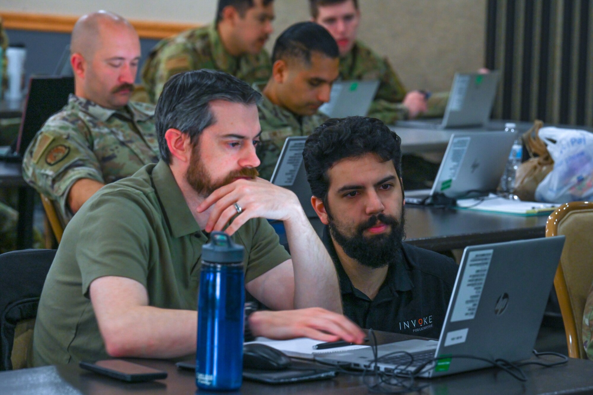 Kamlen Joshi, Invoke robotic processes automation (RPA) instructor, helps a student create an automation during the RPA course at Minot Air Force Base, North Dakota, August 6, 2024. The students learned how simple work processes can go from taking hours to minutes with the help of robotic automatic processes.