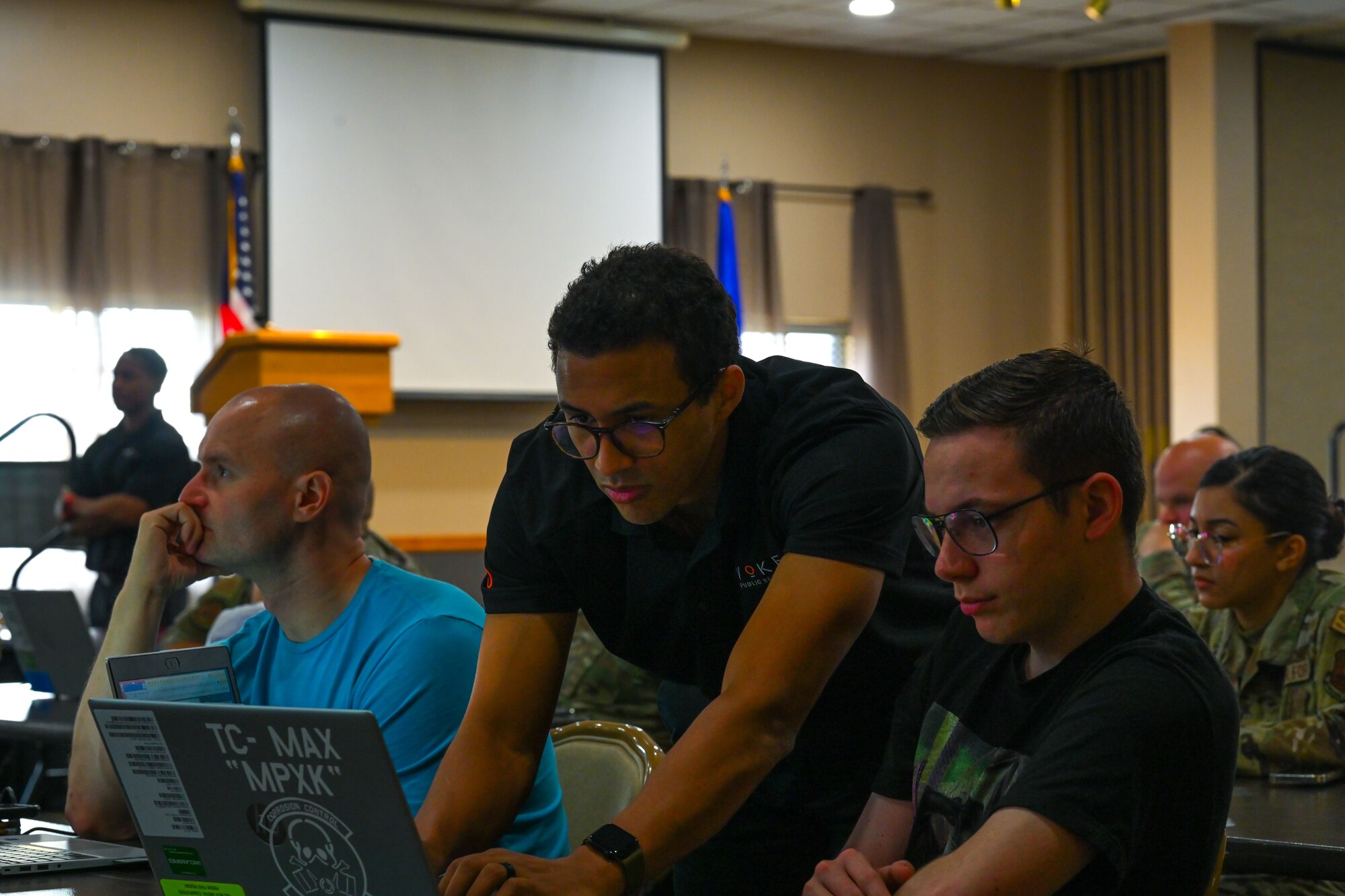 Marcellous Curtis, Invoke robotic processes automation (RPA) instructor, guides a student through creating an automation during the RPA course at Minot Air Force Base, North Dakota, August 6, 2024. The students learned how simple work processes can go from taking hours to minutes with the help of robotic automatic processes.