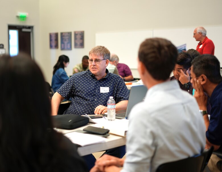 Left of center, Ken Lawler, U.S. Army Corps of Engineers Los Angeles hydraulics civil engineer, discusses an exercise scenario with participants during the Carbon Canyon Dam tabletop exercise July 31, 2024, at the Yorba Linda Water District in Placentia, California.