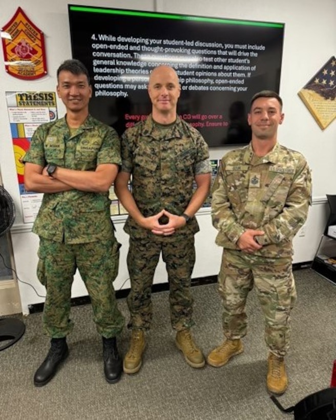 31 July 2024. During a class discussion on Critical and Creative Thinking, Warrant Officer Zhi Wei Ngian, Infantry Leader in the Singapore Army (Left), and Master Sergeant Cesare Szur, US Space Force (right) pause for photo with Conference Group Leader, Gunnery Sergeant Ryan Bradley. Advanced School 4-24, SNCO Academy, Camp Pendleton.  (Photo by GySgt Tacito George)