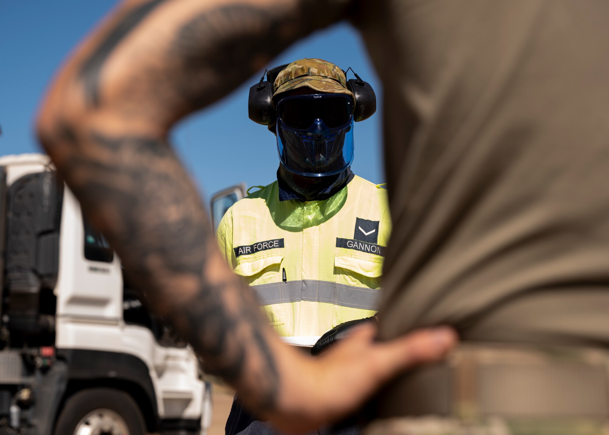 Photo of Royal Australian Air Force Airman speaking to a U.S. Air Force Airman