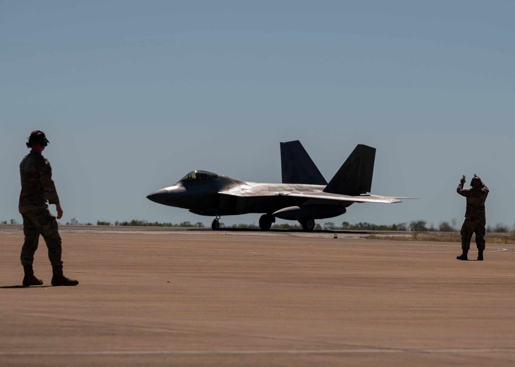 Photo of U.S. Airman marshaling an aircraft