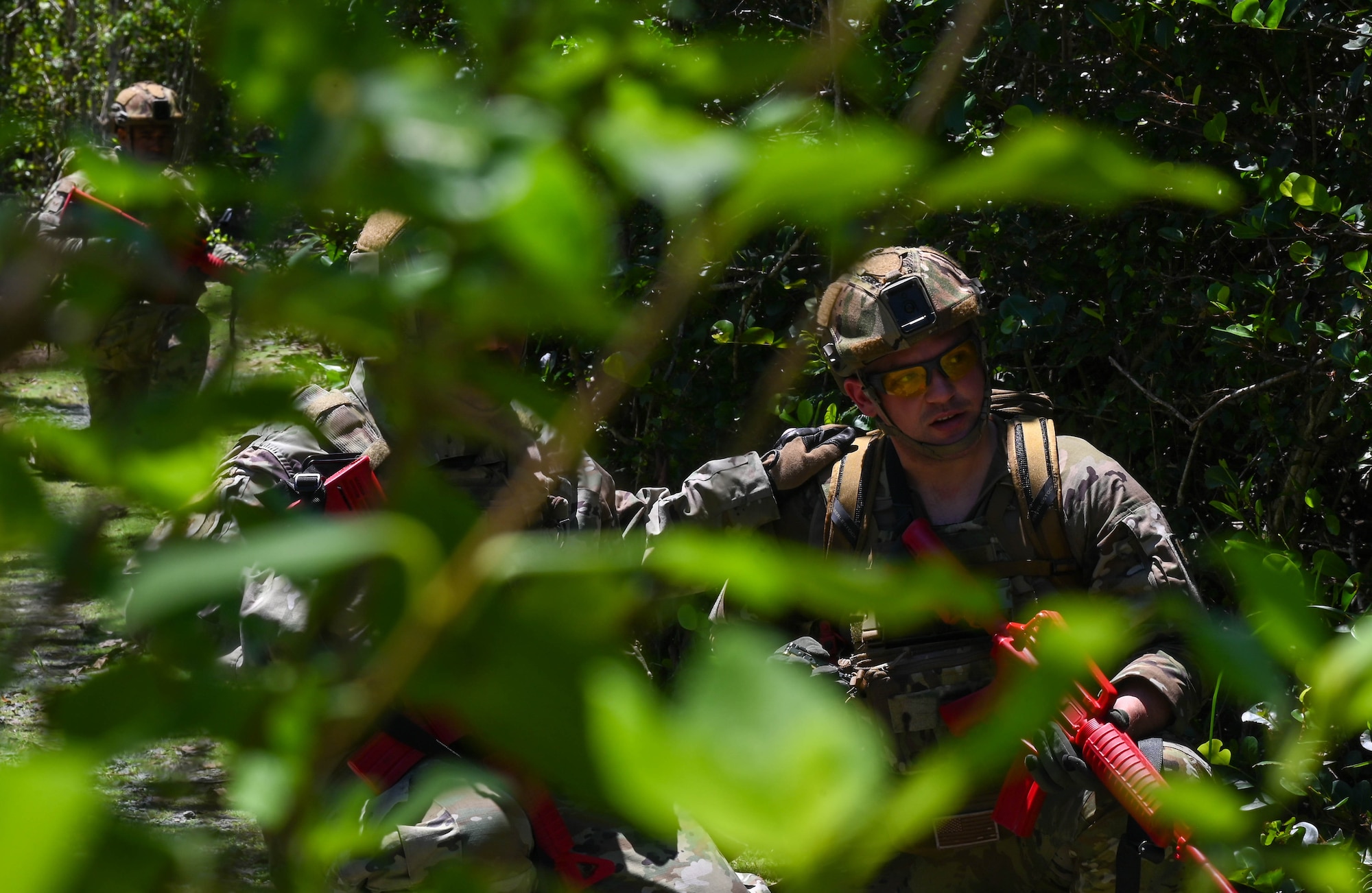 D.C. Air National Guardsmen traverse uneven terrain in file formation to an objective on April 18, 2024, Muniz Air National Guard Base, Puerto Rico.