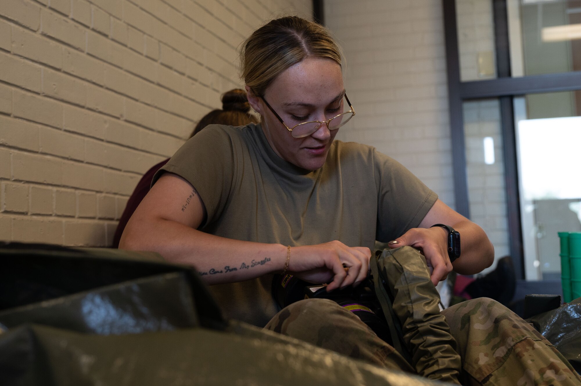 U.S. Air Force Senior Airman Kayla Dia, 436th Medical Group dental flight prophylaxis technician, inspects the integrity of her patient decontamination suit during the Ready Eagle II exercise at Dover Air Force Base, Delaware, Aug. 6, 2024. The exercise was used to test Medical Contingency Response Plan readiness and the current response capabilities for mass casualty care. (U.S. Air Force photo by Senior Airman Dieondiere Jefferies)
