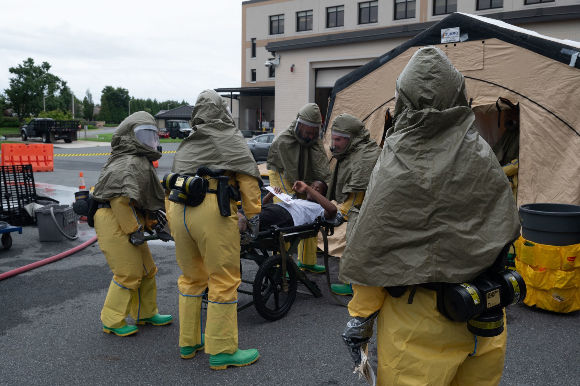 Team Dover Airmen move a patient through a decontamination tent during the Ready Eagle II exercise at Dover Air Force Base, Delaware, Aug. 8, 2024. The exercise was used to test Medical Contingency Response Plan Readiness and the current response capabilities for mass casualty care. (U.S. Air Force photo by Senior Airman Dieondiere Jefferies)